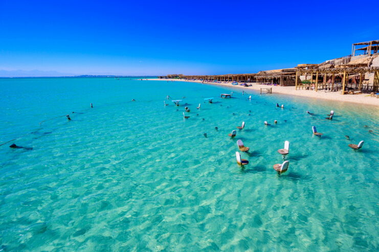 Orange Bay Beach with crystal clear azure water and white beach - paradise coastline of Giftun island, Mahmya, Hurghada, Red Sea, Egypt.